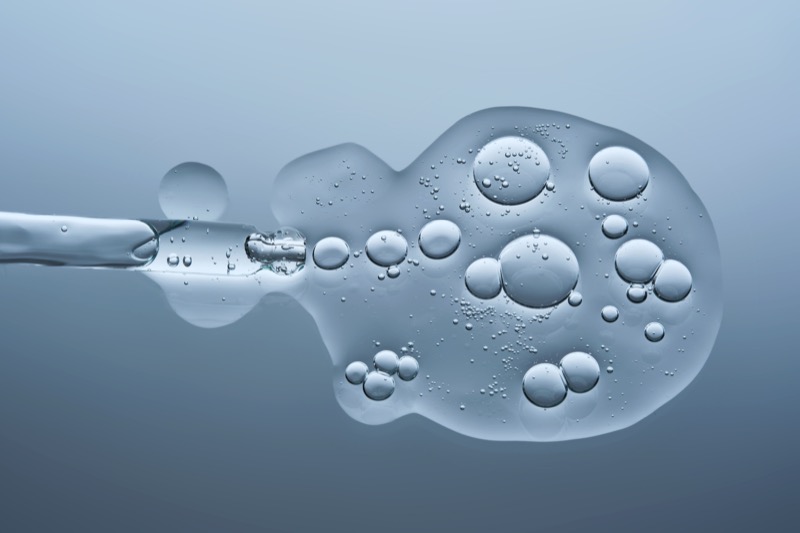Transparent serum with bubbles and laboratory dropper